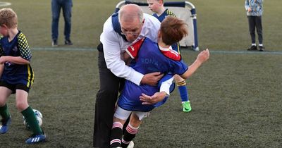 Australian PM stumbles and flattens small boy during footy game on election trail