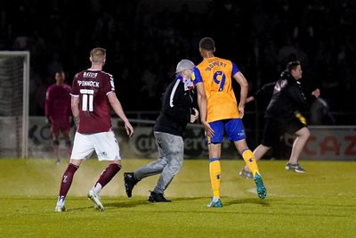 EFL play-offs marred by more disorder as pitch invader barges into Mansfield player