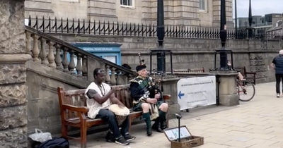 Incredible moment Edinburgh bagpiper and African drummer captured jamming in city centre