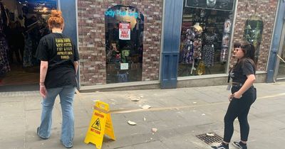 Part of Nottingham shop roof falls on to busy city street