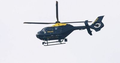 Armed police hunt for 'teens with gun' as helicopter scrambled