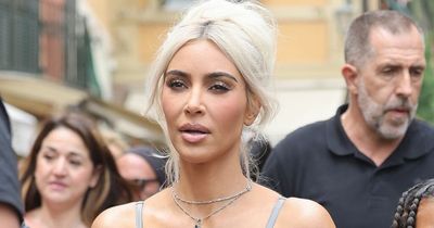 Kim Kardashian breaks cover in skintight catsuit hours before Kourtney's wedding