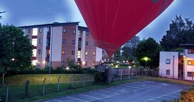 Dramatic moment hot air balloon lands with BUMP in car park after nearly hitting houses