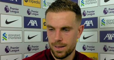 Liverpool captain Jordan Henderson reacts after Man City beat Reds to title
