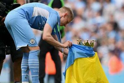 Tearful Oleksandr Zinchenko drapes Premier League trophy in Ukraine flag after Man City triumph