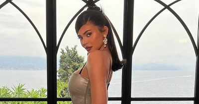 Kylie Jenner dons skin-tight gown and 'celebrates love' at Kourtney's wedding to Travis