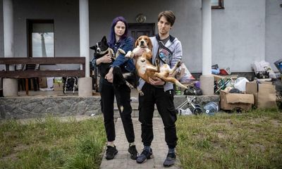 ‘We had too much to do to be scared’: the couple who fled Irpin with 19 dogs