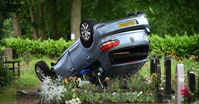 Suspected stolen Golf lands on graves after smashing through cemetery and flipping over