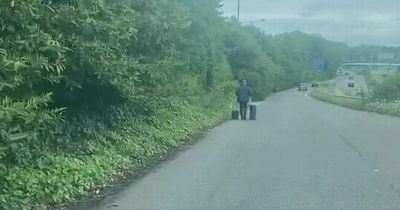 Man seen walking down motorway slip road with suitcases near Manchester Airport