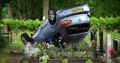 'Stolen' VW Golf lands upside down on top of graves after crashing through cemetery