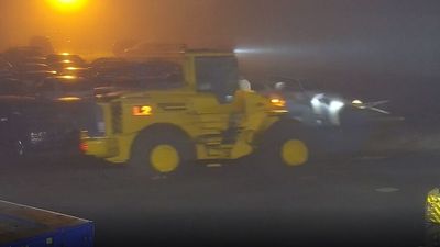 Front-end loader thief smashes into Queensland police holding yard to 're-steal' a Commodore