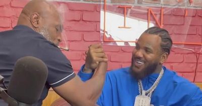 Boxing legend Mike Tyson loses arm-wrestle with rapper while smoking joint