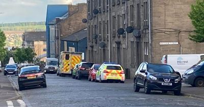 Man rushed to hospital after emergency crews race to Dundee street