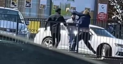 Thugs batter each other on street in brawl outside Scots shop