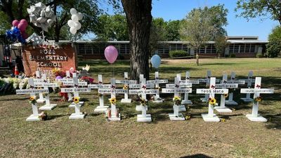 21 crosses stand in front of Uvalde's Robb Elementary to honor those who were killed