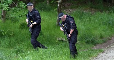 Armed police scour moorland as footpath cordoned off with crime scene tape