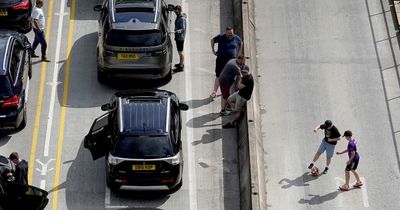 Liverpool fans play football in road during Dover traffic chaos