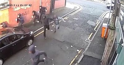 Horrifying moment gunman opens fire yards from children in gangland shooting