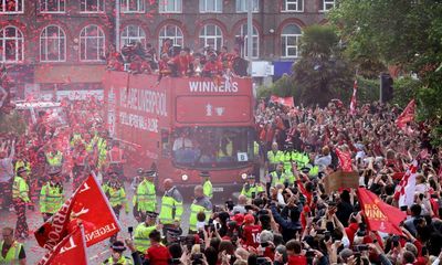 ‘Don’t be sad’: Liverpool fans pack city streets to welcome heroes home