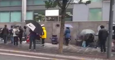 Hundreds camp outside Passport Office in rain as chaos continues