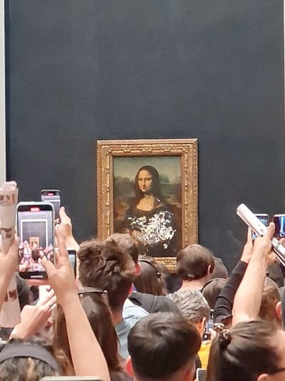 Mona Lisa left unharmed but smeared in cream in climate protest stunt