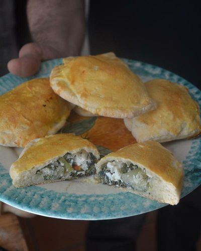 Rachel Roddy’s recipe for Sicilian-inspired bread with greens and cheese