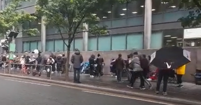 Huge queues see people bringing camping chairs as they wait for new passports