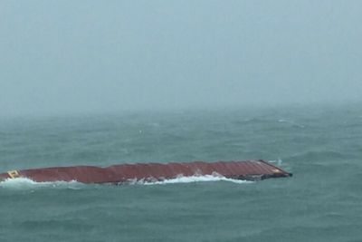 Containers swept overboard in stormy seas, wash up on Satun beach