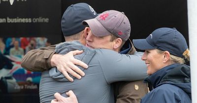 Prince William enjoys bear hug with Mike Tindall during playful encounter at horse show