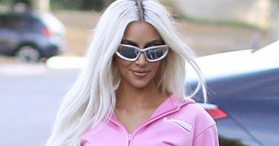 Kim Kardashian is a real life Barbie as she pours hourglass curves into pink lycra