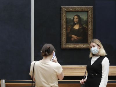 A man in a wig was detained after throwing a piece of cake at the Mona Lisa