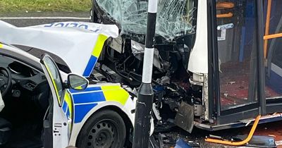 Police car on emergency callout smashes head-on into double-decker bus leaving officer injured