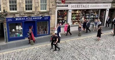 Heartwarming moment newlywed Edinburgh couple are piped down Royal Mile