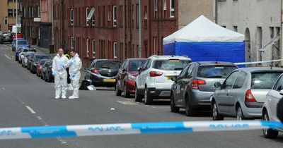 Police forensics comb street after man dies and woman seriously injured in Johnstone