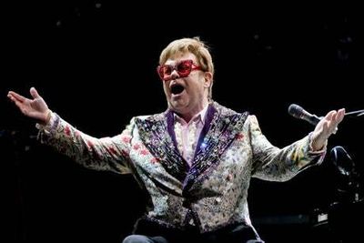 Elton John says he’s ‘in top health’ after being spotted in wheelchair at German airport