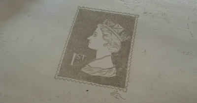 Sand artist creates giant first class stamp featuring portrait of The Queen on Bamburgh beach