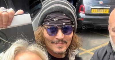 Beaming Johnny Depp all smiles in Glasgow as he mingles with fans ahead of Jeff Beck gig