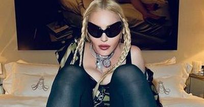 Madonna straddles bed in stockings in raunchy snap swiftly shaded by 50 Cent