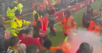 Liverpool fan bloody and burned after being hit in the face by lit flare