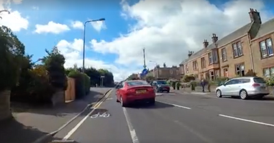 Worried Edinburgh dad films near miss with cars while cycling past primary school