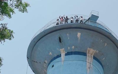 Mission Bhagiratha workers climb water tank