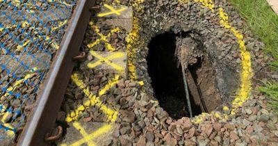 Huge sinkhole beside Scots railway line leads to suspended services as engineers probe discovery
