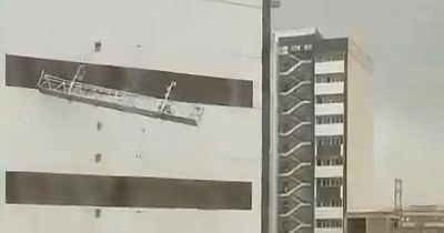 Workers plunge to their deaths as apocalyptic dust storm batters high rise building