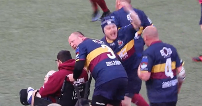 Injured rugby player in wheelchair pushed over the try line by team-mates in moment that's moved fans