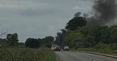 Vehicle bursts into flames after three-car crash as emergency services race to Scots road