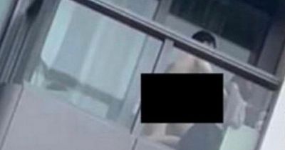Randy couple caught during daring balcony sex as viral footage sees woman arrested