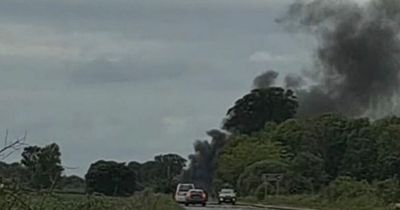 Man dies after horror fireball crash on busy Scots road as BMW collides with farm vehicles