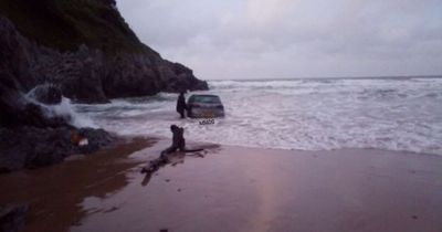 People rescued after their car ends up partly submerged in the sea at a Gower beach