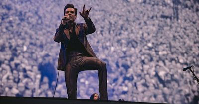 Watch as The Killers invite young fan onstage to play drums at Old Trafford gig