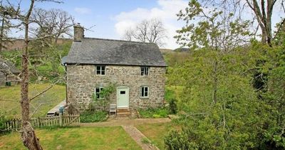 The pretty country cottage that comes with a former owner buried in the garden